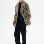 Alternate front view of leopard peacoat on model wearing black top and pants, against a white background.