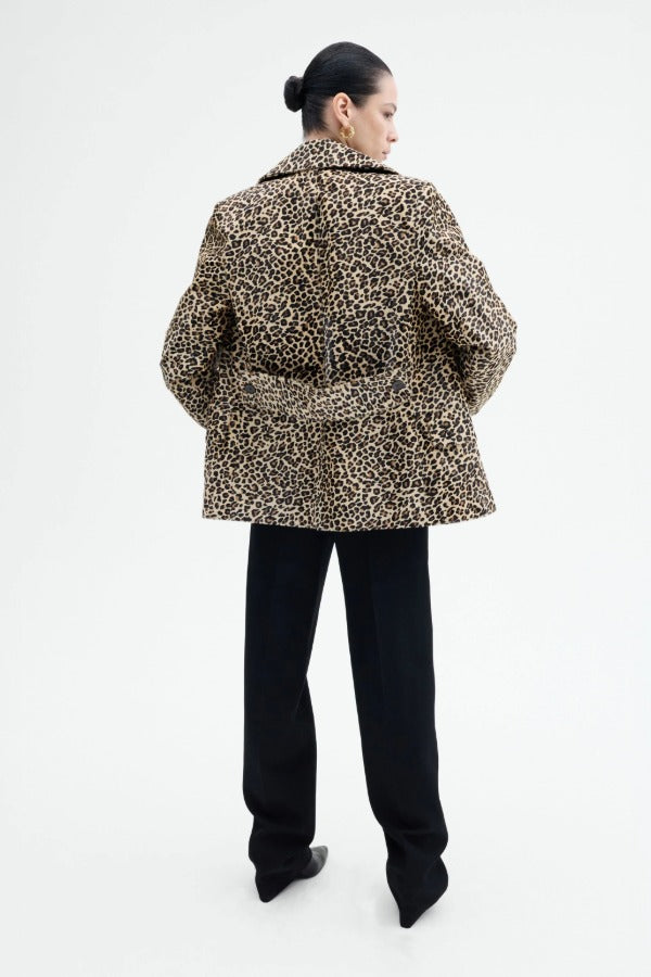 Back view of leopard peacoat on model wearing black pants, against a white background.