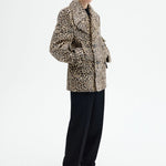 Alternate side view of leopard peacoat on model wearing black top and pants, against a white background.