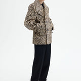 Alternate side view of leopard peacoat on model wearing black top and pants, against a white background.