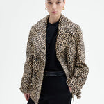 Front view of leopard peacoat on model wearing black top and pants, against a white background.