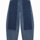 Front view of indigo denim patchwork pants on white background, with no model shown.