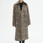 Front view of leopard coat on model wearing black top and flats, against a white background.