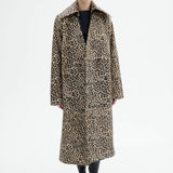 Front view of leopard coat on model wearing black top and flats, against a white background.