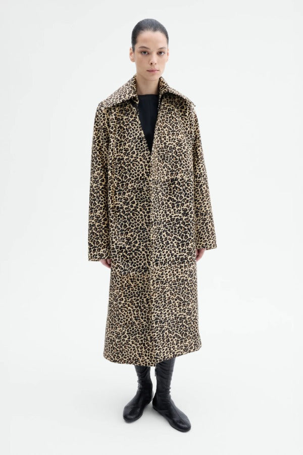 Front view of leopard coat on model wearing black top and flats, against a white background.