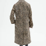 Back view of leopard coat on model wearing black flats, against a white background.