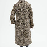 Back view of leopard coat on model wearing black flats, against a white background.