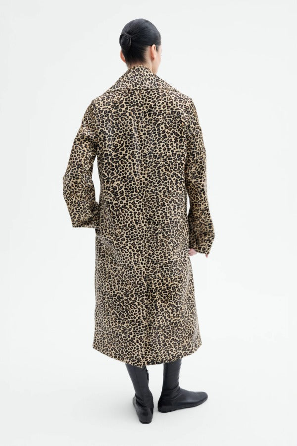 Back view of leopard coat on model wearing black flats, against a white background.