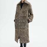 Front view of leopard coat on model wearing black top and flats, against a white background.