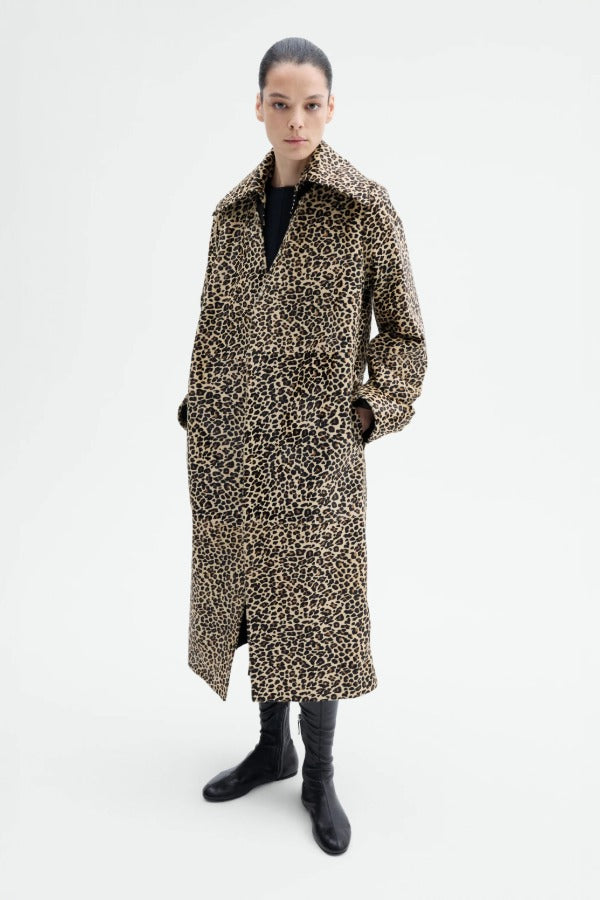 Front view of leopard coat on model wearing black top and flats, against a white background.