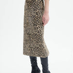 Alternate side view of leopard skirt on model wearing black top and boots, against a white background.