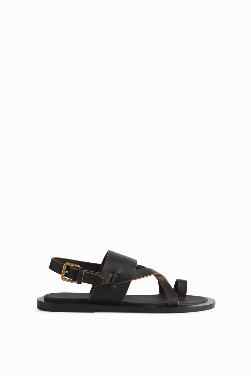 The left black leather sandal is shown in a side view profile with buckle shown in the back on white background.