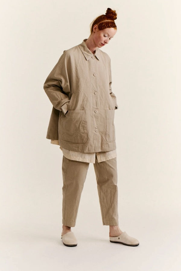 Front slanted view of oatmeal tatiana jacket on model wearing khaki pants and white clogs, against a white background.