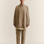 Front view of oatmeal tatiana jacket on model wearing khaki pants and white clogs, against a white background.