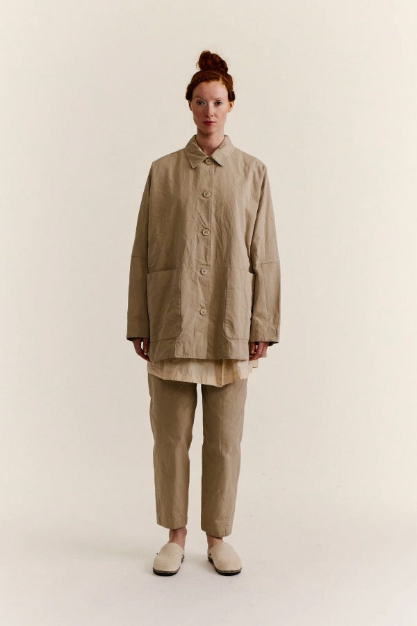 Front view of oatmeal tatiana jacket on model wearing khaki pants and white clogs, against a white background.