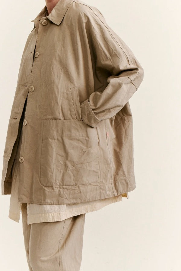 Side closeup view of oatmeal tatiana jacket on model wearing khaki pants, against a white background.