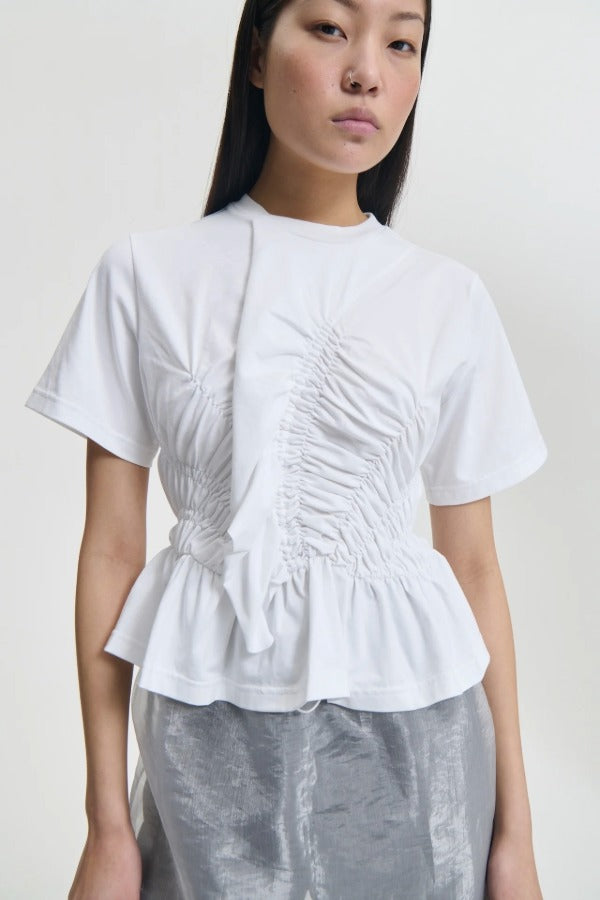 Front closeup view of white ace t-shirt on model, against a white background