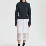 Front view of white bria skirt on model wearing grey sweater and black sneakers, against a white background.