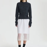 Front view of white bria skirt on model wearing grey sweater and black sneakers, against a white background.