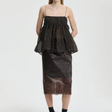 Front view of soil brown veronica top on model wearing brown skirt and sneakers with socks, against a white background.