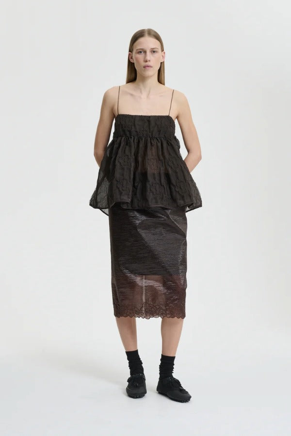 Front view of soil brown veronica top on model wearing brown skirt and sneakers with socks, against a white background.
