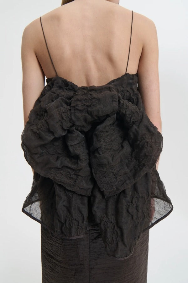 Back closeup view of soli brown veronica top on model wearing brown skirt, against a white background.