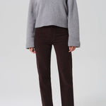 Front view of barrister caia pants on model wearing grey sweater and heels, against a white background.
