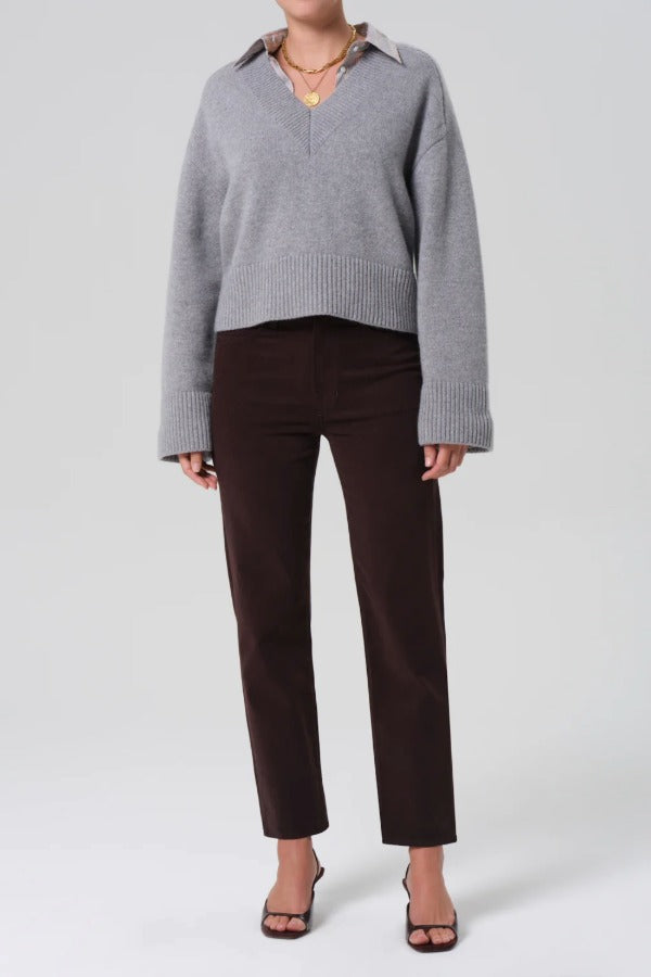 Front view of barrister caia pants on model wearing grey sweater and heels, against a white background.