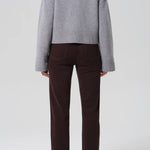 Back view of barrister caia pants on model wearing grey sweater and heels, against a white background.