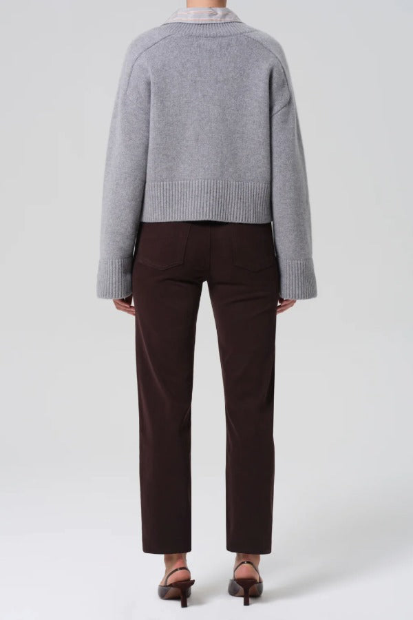 Back view of barrister caia pants on model wearing grey sweater and heels, against a white background.