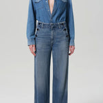 Front view of boardwalk trouser in jete on model wearing jean shirt and black heels, against a white background.