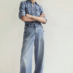 Front view of boardwalk trouser in jete on model wearing jean shirt and black sandals, against a white background.