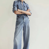 Front view of boardwalk trouser in jete on model wearing jean shirt and black sandals, against a white background.