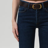 Front closeup view of blaine jean in medina on model wearing black and white tank tops with a brown and gold belt, against a white background.