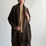 Front view of cappucino mongolian nubby stole on model wearing camel shirt and pants, against a white background.