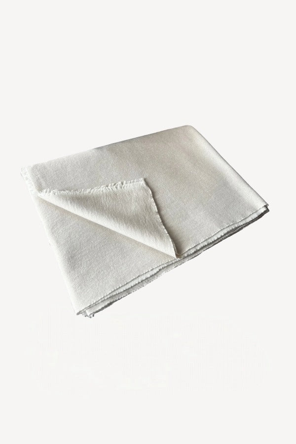 Front folded view of feather and jute reversible throw on white background, with no model shown.