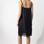 Back view of midnight chemise slip on model, against a white background.