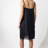 Back view of midnight chemise slip on model, against a white background.