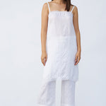 Front view of rice chemise slip on model wearing rice pants and natural sandals, against a white background.