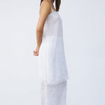 Side view of rice chemise slip on model wearing rice pants and natural sandals, against a white background.