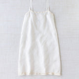 Front view of rice chemise slip on white background, with no model shown.