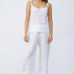 Front view of rice kymber camisole on model wearing rice pants and natural sandals, against a white background.