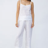 Front view of rice kymber camisole on model wearing rice pants and natural sandals, against a white background.