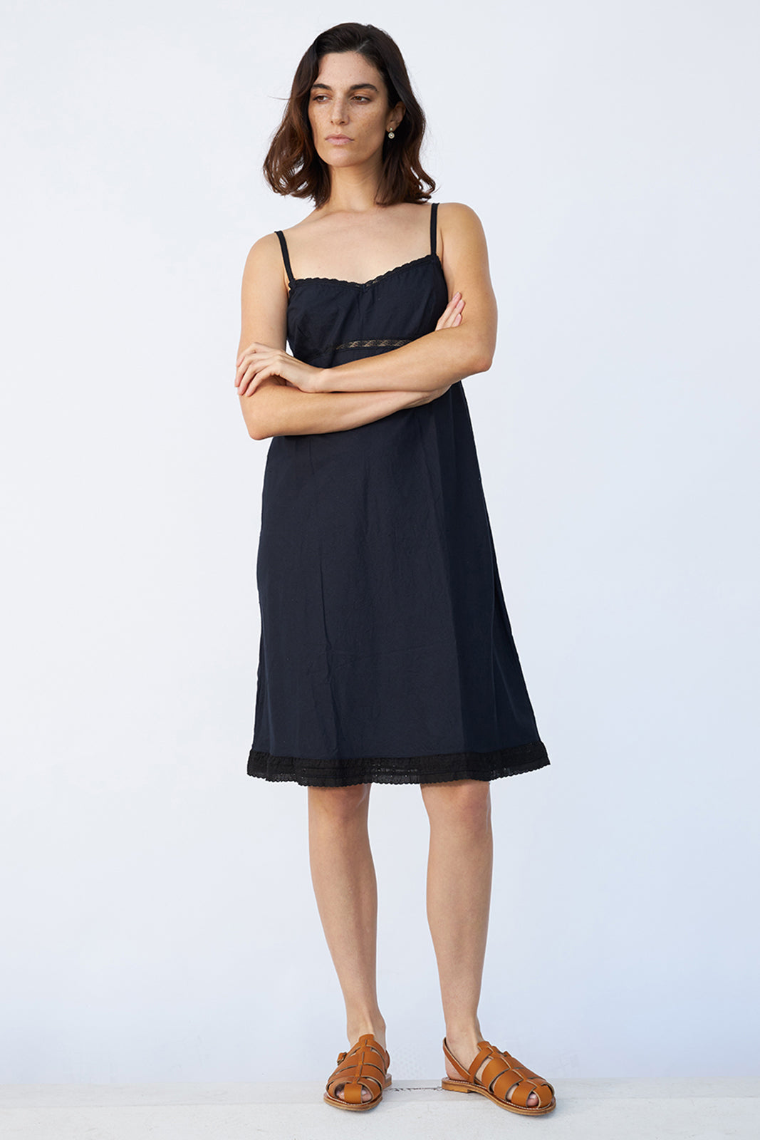 Front view of midnight kymber slip on model wearing natural sandals, against a white background.