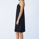 Side view of midnight kymber slip on model wearing natural sandals, against a white background.