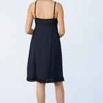 Back view of kymber slip on model wearing natural sandals, against a white background.