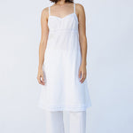 Front view of rice kymber slip on model wearing natural sandals, against a white background.