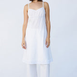 Front view of rice kymber slip on model wearing natural sandals, against a white background.