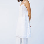 Side view of rice kymber slip on model wearing rice pants and natural sandals, against a white background.
