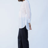 Side view of rice little subhash shirt on model wearing midnight pants and natural shoes, against a white background.